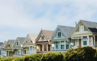 Debt Collection Solutions for Property Managers: Image of colorful houses symbolizing a residential property managed by a debt collection agency to recover unpaid rent.