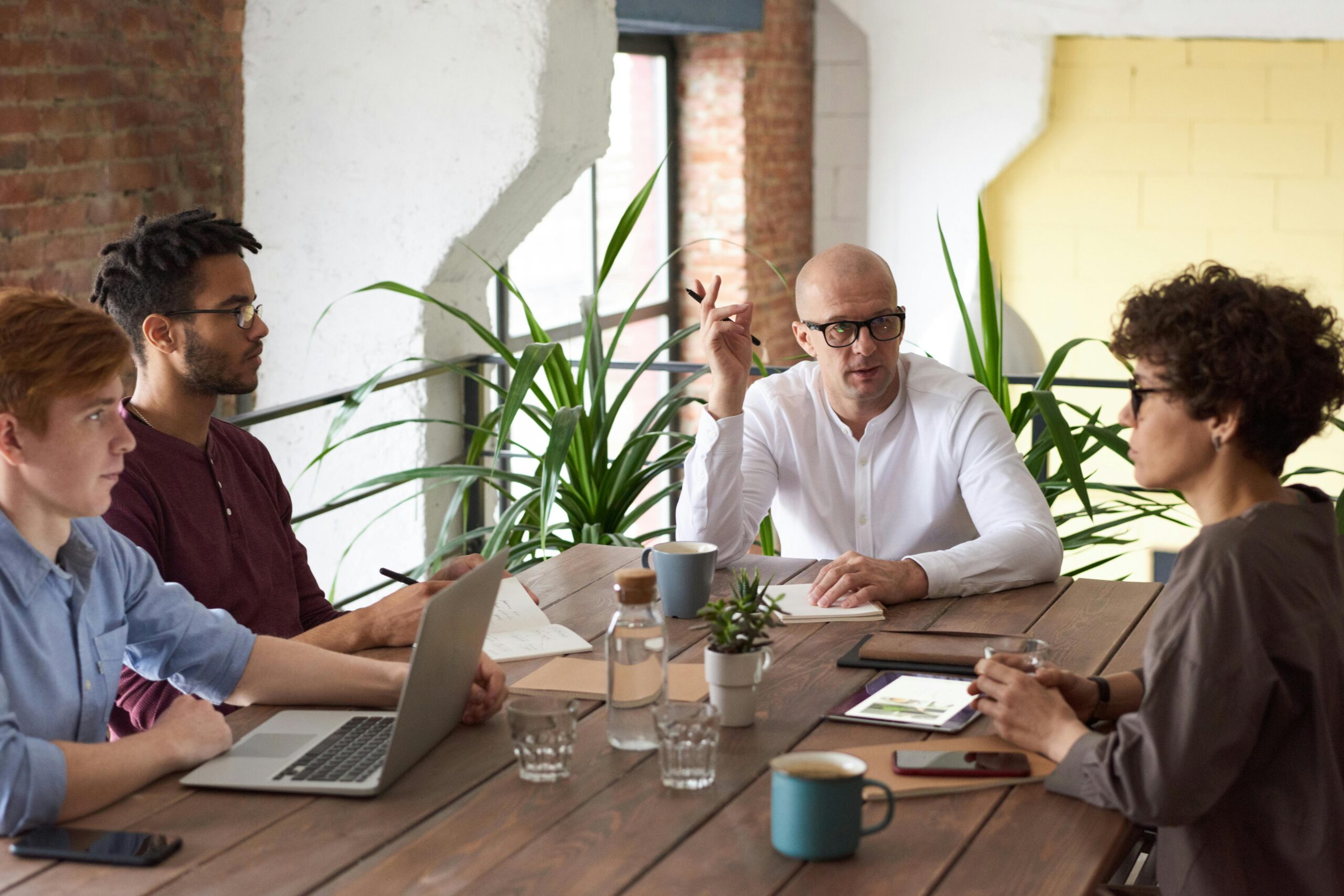 "Ethical Debt Collection Team Meeting" - A group of professionals discussing transparent and fair debt recovery strategies in an office setting.