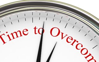 Debt Collection Challenges: Clock face with the words "time to overcome" written on it, representing the urgency to resolve debt collection issues.