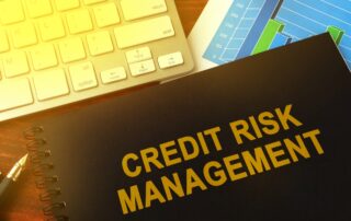 Close-up of a computer keyboard with text on the screen reading “Credit Risk Management”
