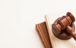 Debt Collection Laws: A wooden gavel on law books, representing the 2024 legal landscape for debt collection.