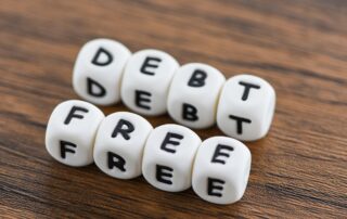 Debt Prevention for Businesses: White blocks spelling out "debt free," representing a business's goal of financial freedom through effective debt prevention.