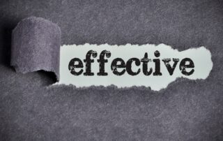 Effective Debt Collection: A close-up photo of a ripped piece of paper revealing the word "effective" in bold letters, emphasizing the importance of effective debt collection strategies for businesses.