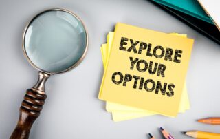 Debt Collection Agencies: A magnifying glass emphasizes the words "Explore Your Options" on a sticky note, symbolizing the importance of researching debt collection choices.