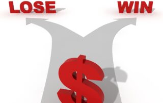 Managing Business Stress: Red dollar sign standing at a decision point on a gray split arrow. The text "Win" is written on one side of the arrow and "Lose" is written on the other side. This image metaphorically represents the financial uncertainty a business owner may experience.