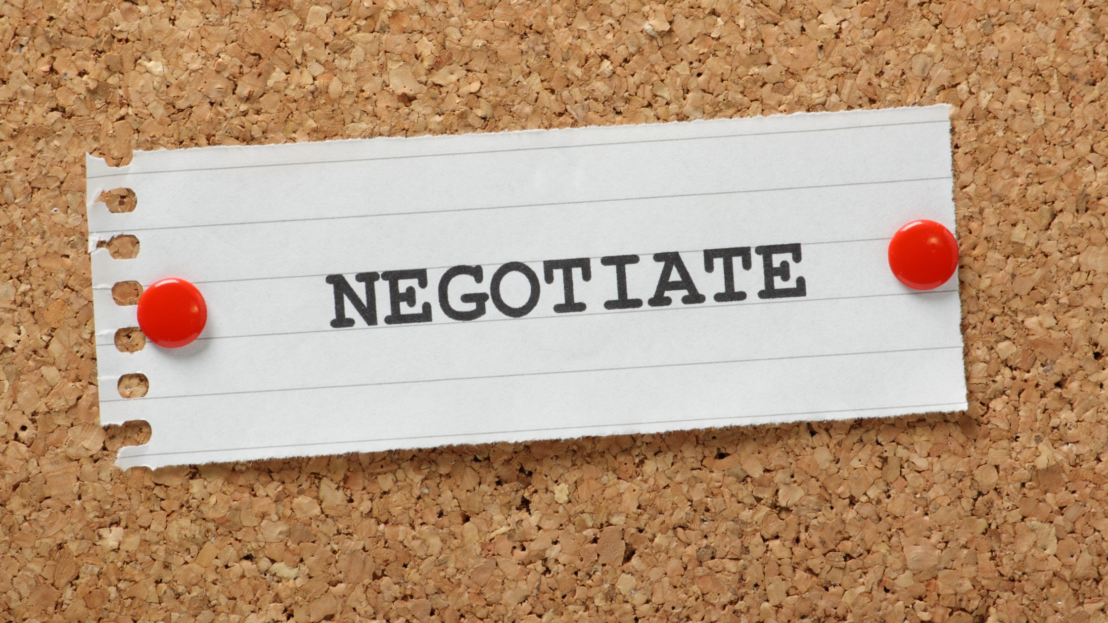 Negotiate Debt Settlements: Image of a piece of paper pinned to a corkboard with the word "Negotiate" written on it in black ink. Debt settlement concept.