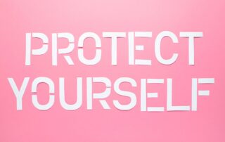 Debt Collection Scams: White cutout letters spelling "PROTECT YOURSELF" on a pink background, reminding viewers to be vigilant against debt collection scams.
