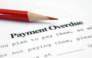 Commercial Debt Collection: A red pencil points to the words "Payment Overdue" on a debt collection notice, highlighting the need for innovative AI-driven solutions to improve commercial debt recovery.