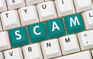 Debt Collection Scams Targeting Businesses: Computer keyboard with the word SCAM highlighted, representing the threat of debt collection scams targeting businesses.