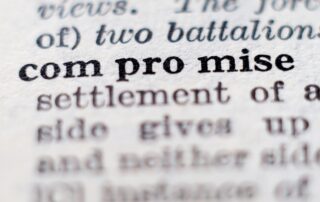 Close-up image of dictionary definition of "compromise," emphasizing its importance in debt negotiation and settlement.